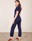 Side view of Short Sleeve Jumpsuit in Navy Blue worn by Alex