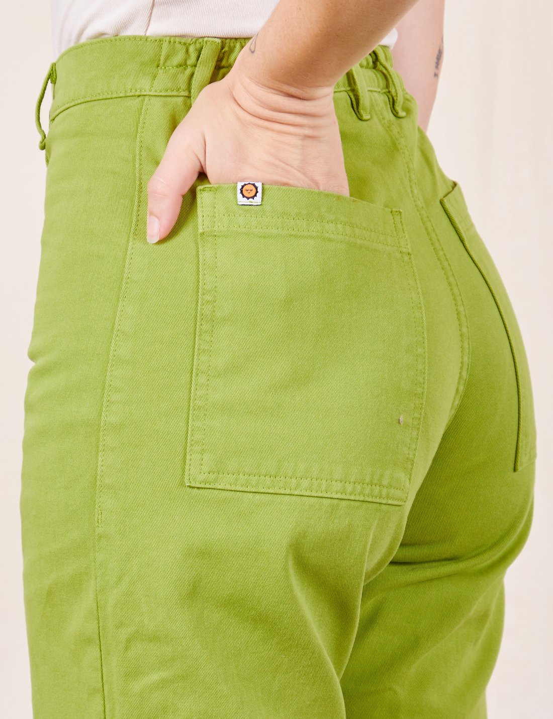 Western Pants in Gross Green back pocket close up on Alex