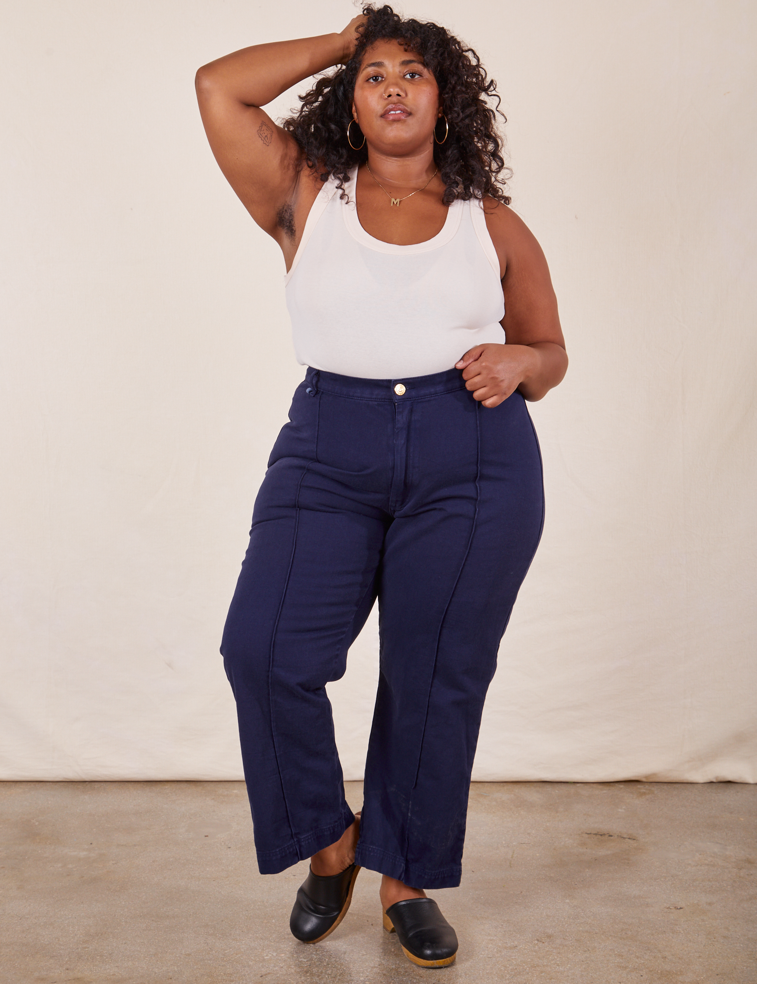 Morgan is 5&#39;5&quot; and wearing 1XL Western Pants in Navy Blue paired with vintage off-white Tank Top