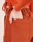 Work Pants in Burnt Terracotta back pocket close up on Alex