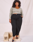 Morgan is 5'5" and wearing 1XL Heritage Trousers in Basic Black paired with khaki grey Long Sleeve V-Neck Tee