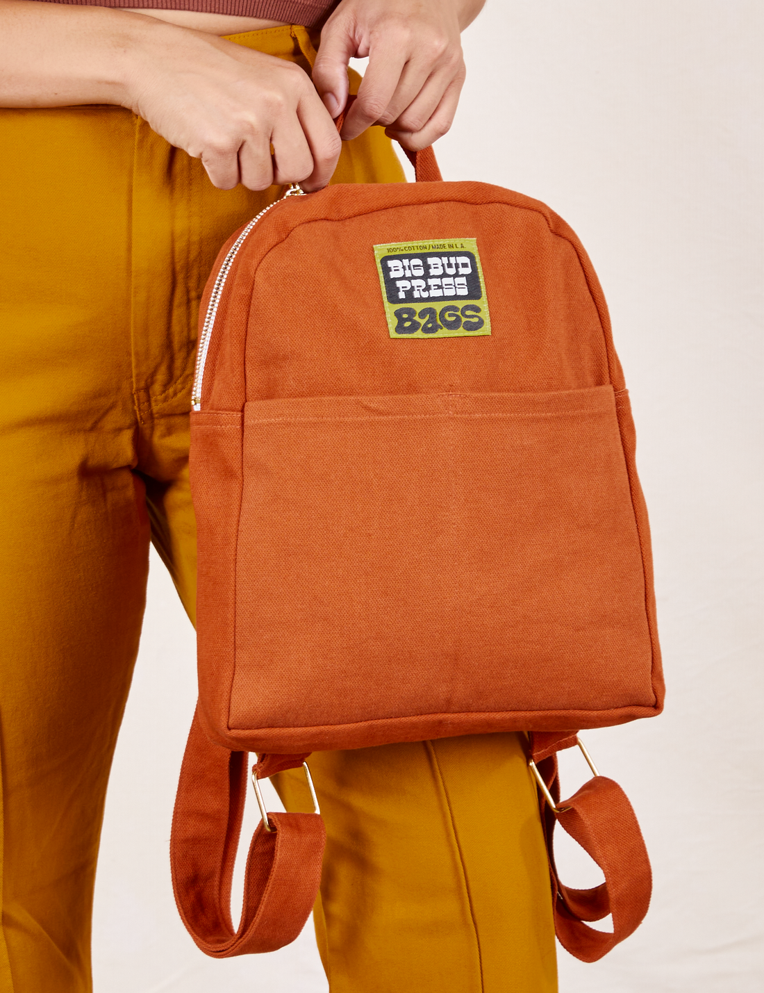 Mini Backpack in Burnt Terracotta held by Tiara