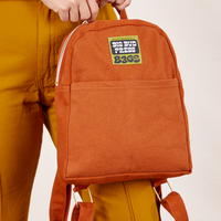 Mini Backpack in Burnt Terracotta held by Tiara