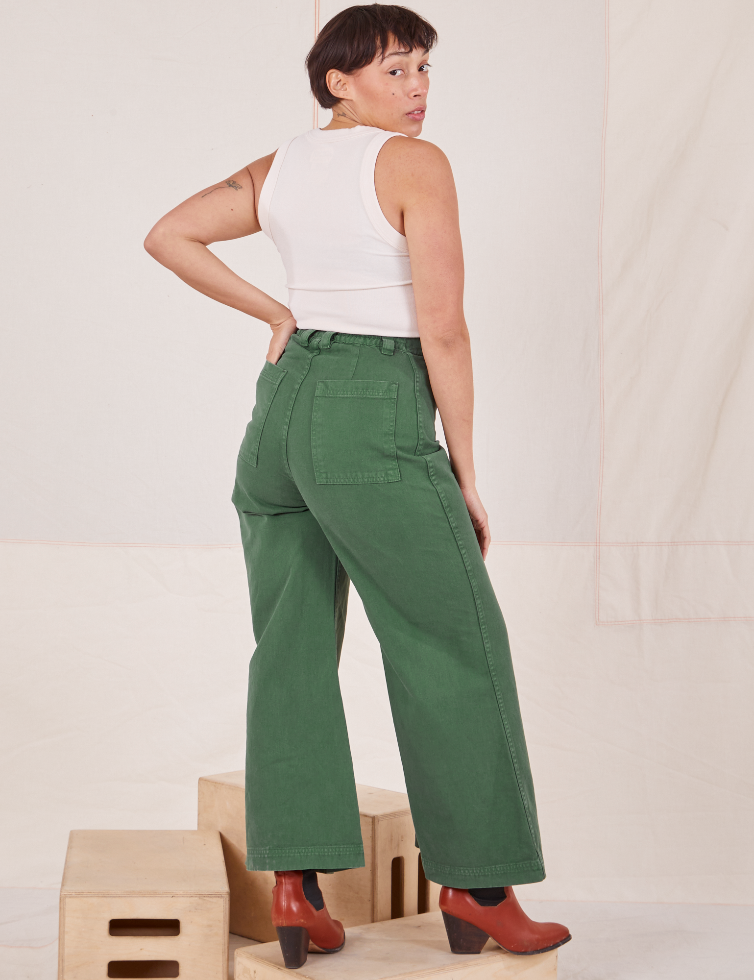 Back view of Bell Bottoms in Dark Emerald Green and vintage off-white Tank Top worn by Tiara