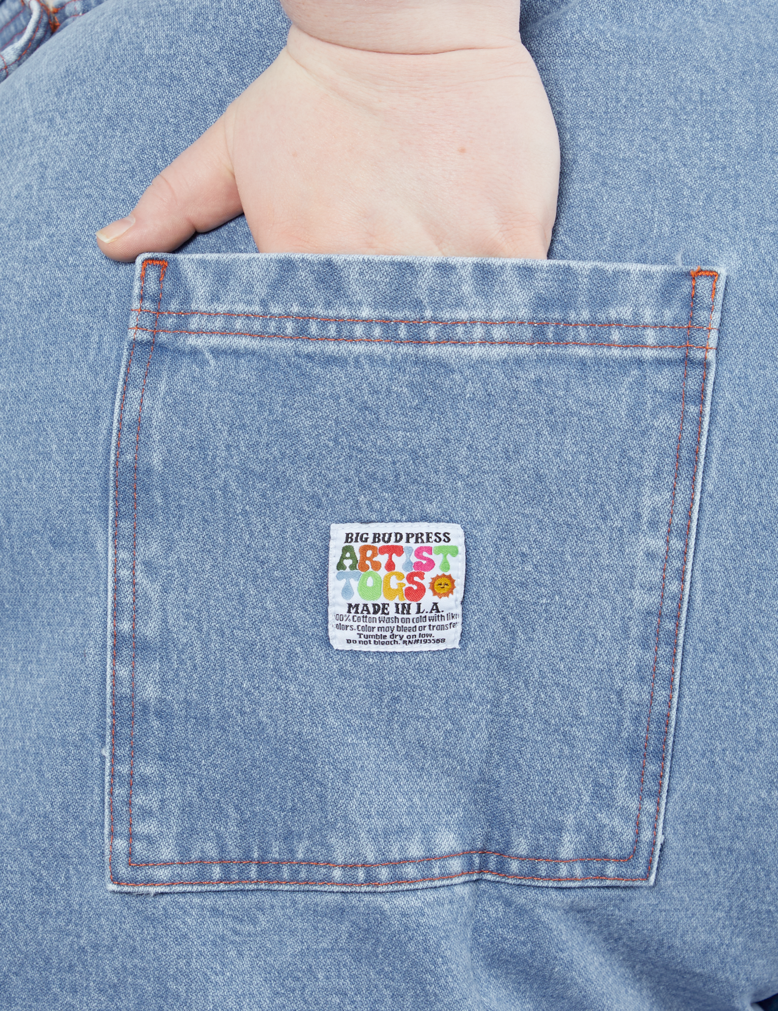 Indigo Denim Original Overalls in Light Wash hand in back pocket on Catie