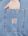 Indigo Denim Original Overalls in Light Wash hand in back pocket on Catie