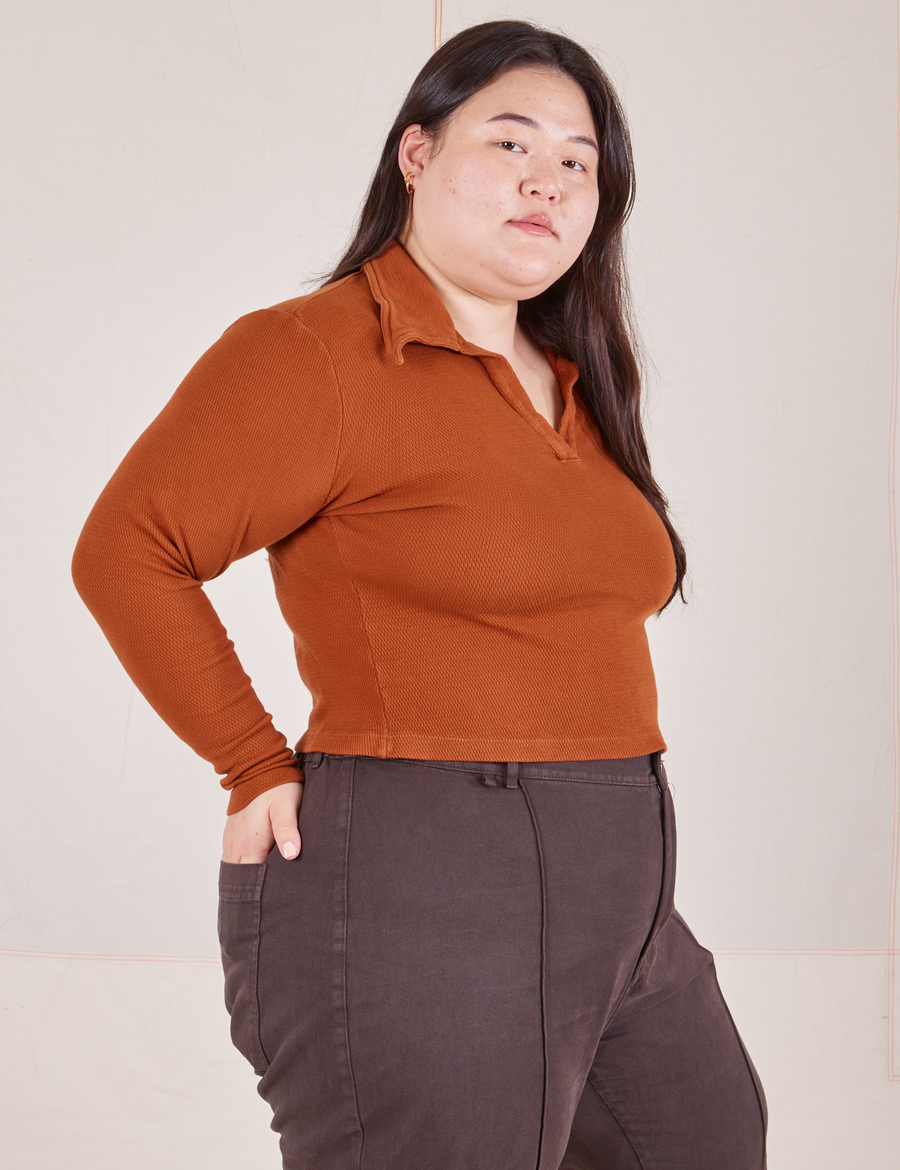 Angled view of Long Sleeve Fisherman Polo in Burnt Terracotta worn by Ashley