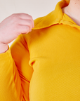 Front close up of Long Sleeve Fisherman Polo in Sunshine Yellow worn by Catie