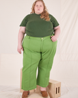 Catie is wearing 3XL Organic Vintage Tee in Dark Emerald Green paired with gross green Western Pants