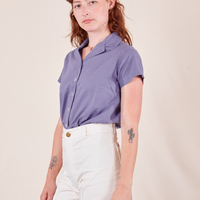 Angled view of Pantry Button-Up in Faded Grape and vintage off-white Western Pants worn by Alex