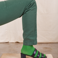 Pencil Pants in Dark Emerald Green leg close up wearing Everyday Sock in kelly green