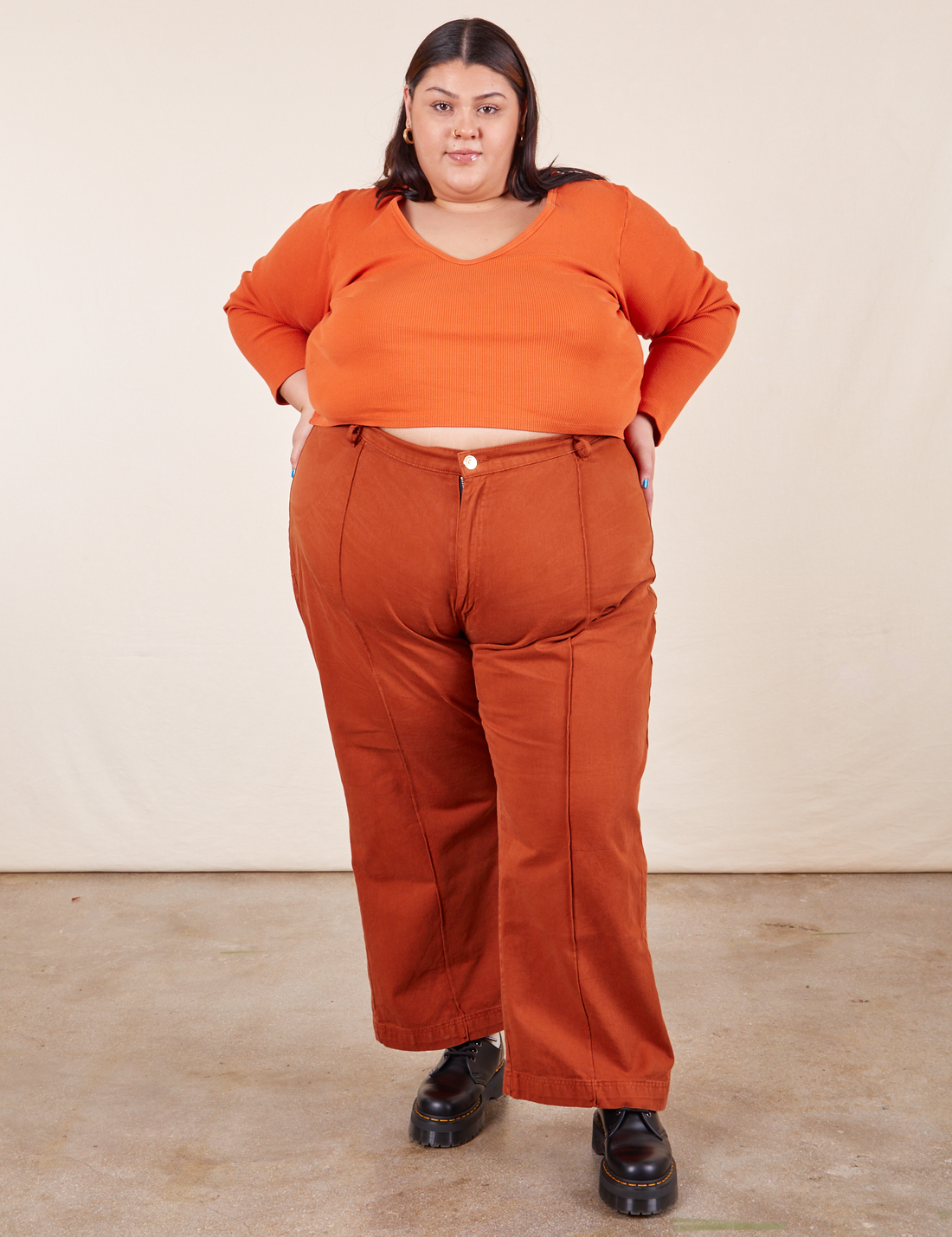 Western Pants in Burnt Terracotta on Sarita wearing burnt orange Long Sleeve V-Neck