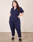 Ashley is 5'7" and wearing 1XL Short Sleeve Jumpsuit in Navy Blue