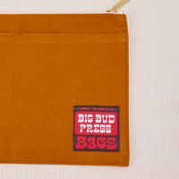 Big Pouch in Spicy Mustard with big bud press label in red and brown