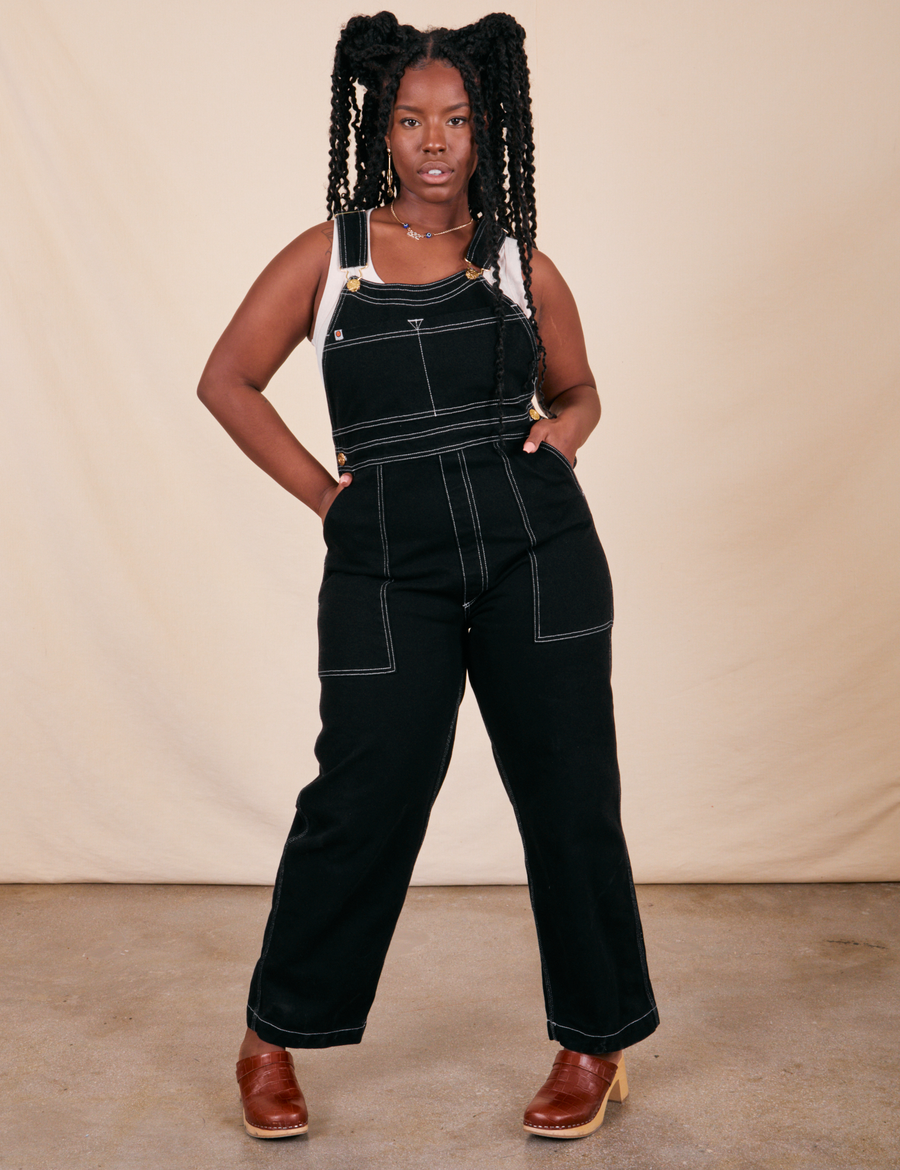 Shai is 5'5" and wearing M Original Overalls in Basic Black