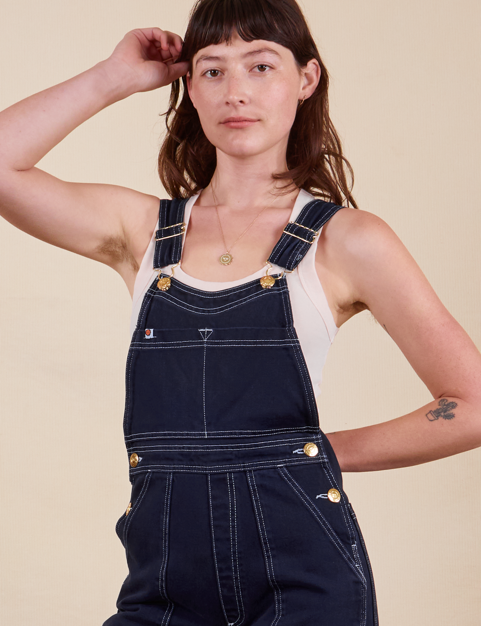 Alex is wearing Original Overalls in Navy Blue and vintage off-white Tank Top