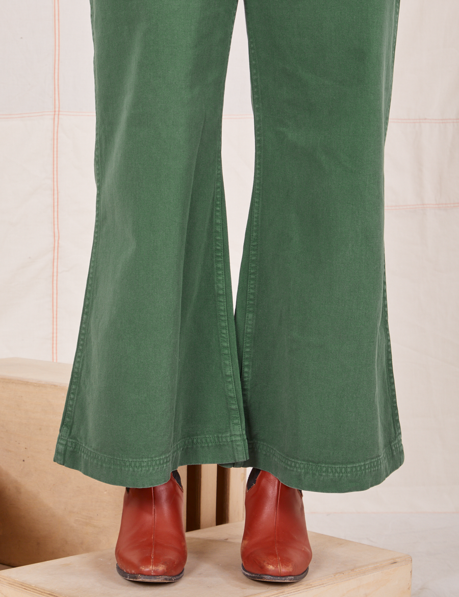 Pant leg close up of Bell Bottoms in Dark Emerald Green worn by Tiara