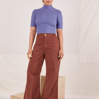 Mika is wearing size P 1/2 Sleeve Essential Turtleneck in Faded Grape paired with fudgesicle brown Bell Bottoms