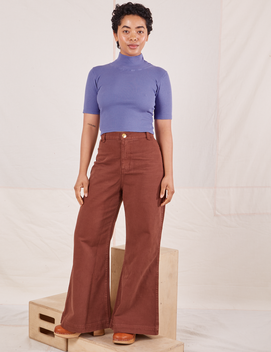 Mika is wearing size P 1/2 Sleeve Essential Turtleneck in Faded Grape paired with fudgesicle brown Bell Bottoms
