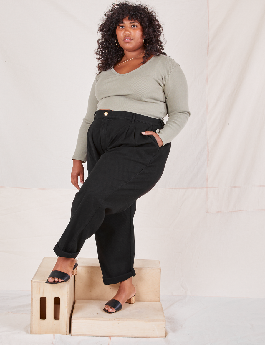 Morgan is wearing Heritage Trousers in Basic Black and khaki grey Long Sleeve V-Neck Tee