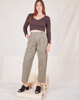 Allison is 5'10" and wearing S Heritage Trousers in Khaki Grey paired with espresso brown Long Sleeve V-Neck Tee