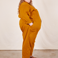 Side view of Everyday Jumpsuit in Spicy Mustard worn by Catie