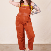Sydney is 5'9" and wearing M Original Overalls in Burnt Terracotta