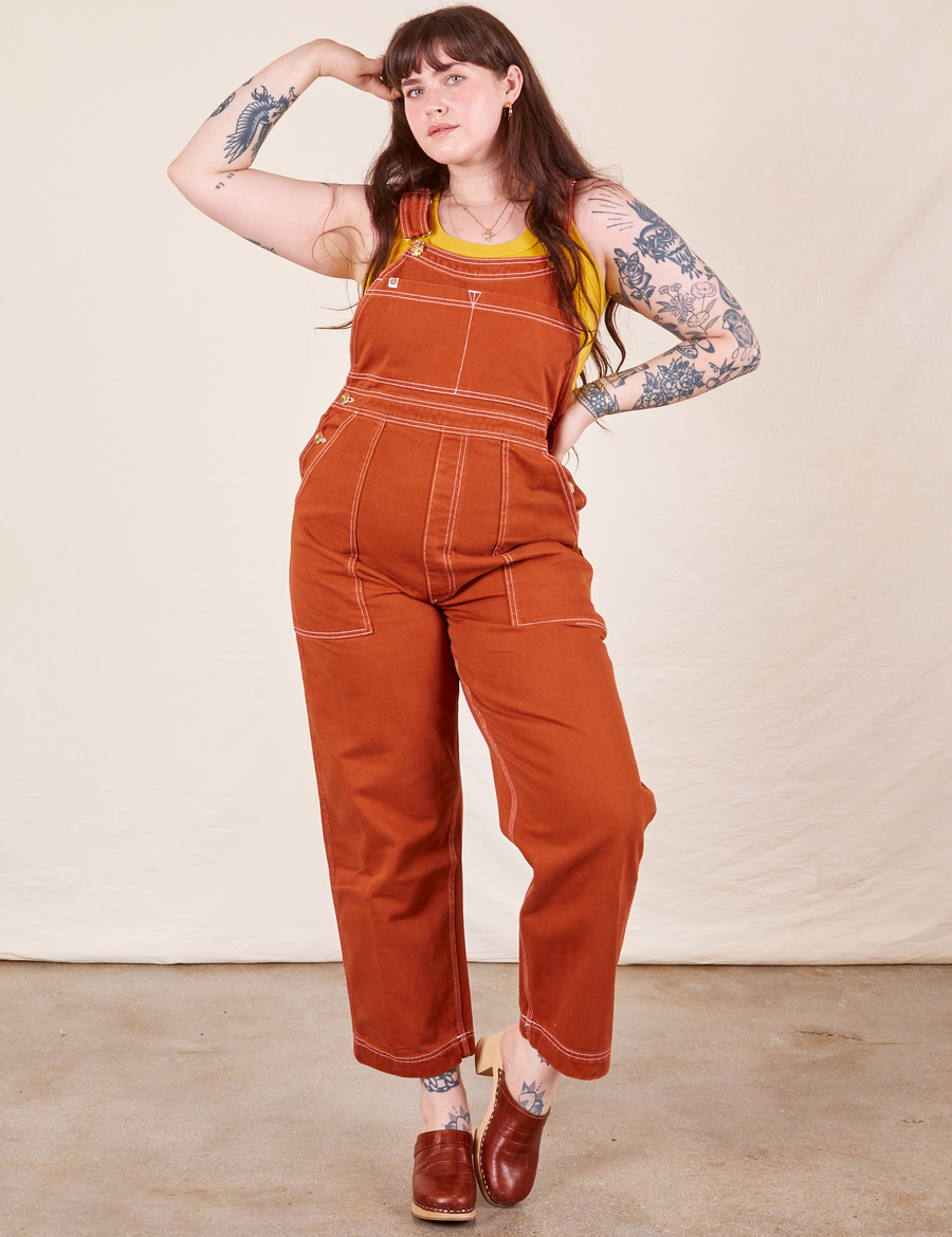 Sydney is 5'9" and wearing M Original Overalls in Burnt Terracotta