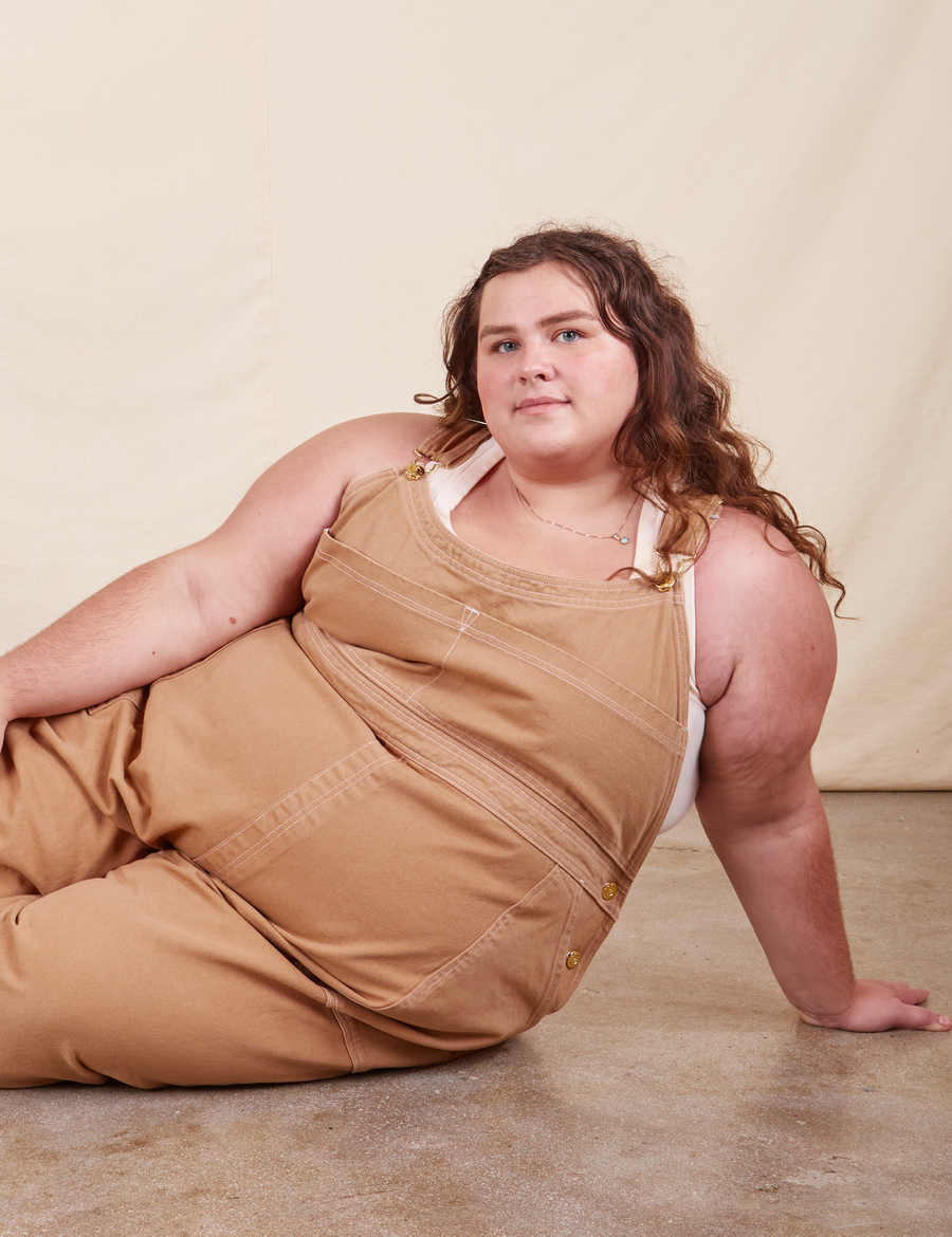 Mara is wearing Original Overalls in Tan and vintage off-white Tank Top