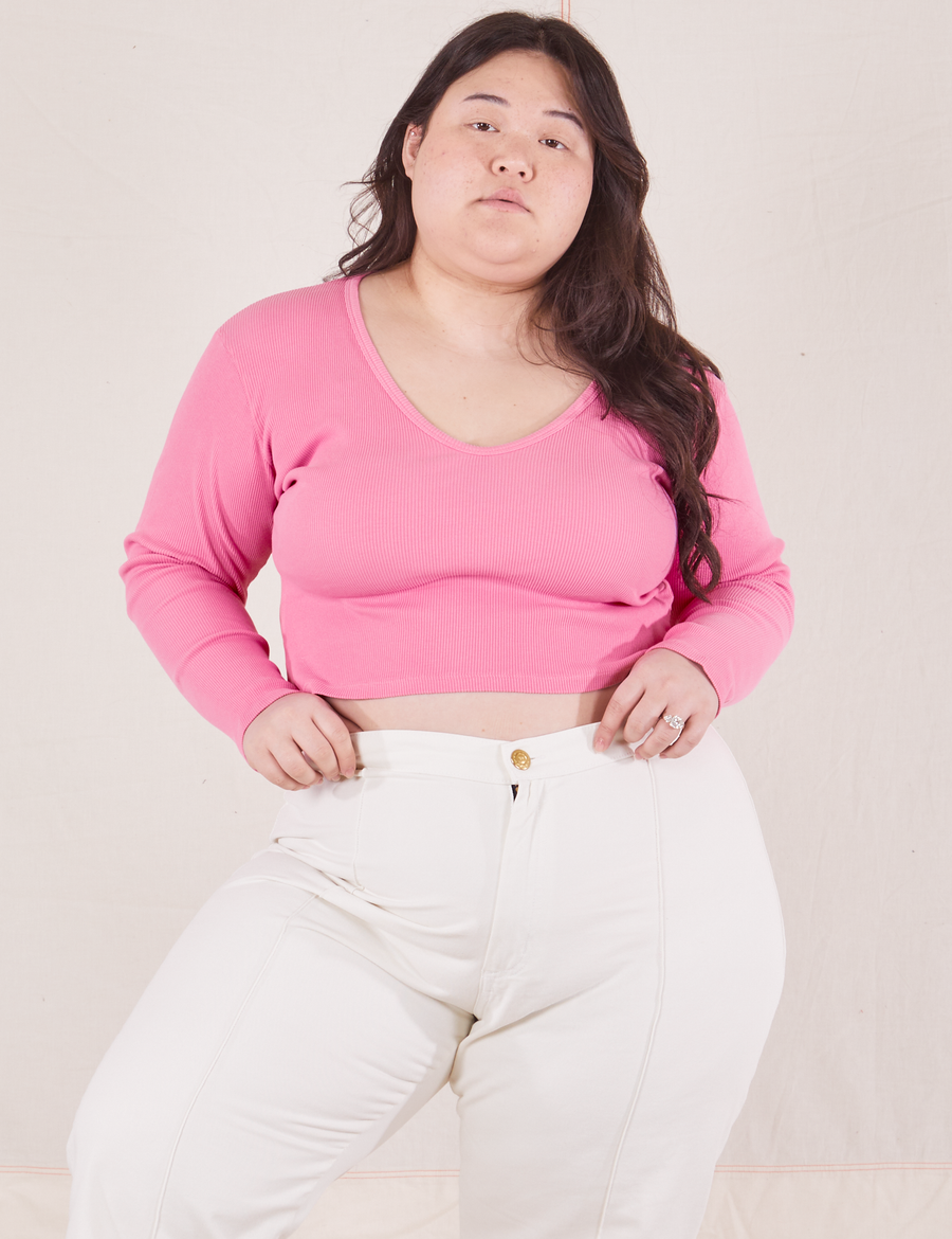 Ashley is wearing size L  Long Sleeve V-Neck Tee in Bubblegum Pink paired with vintage off-white Western Pants