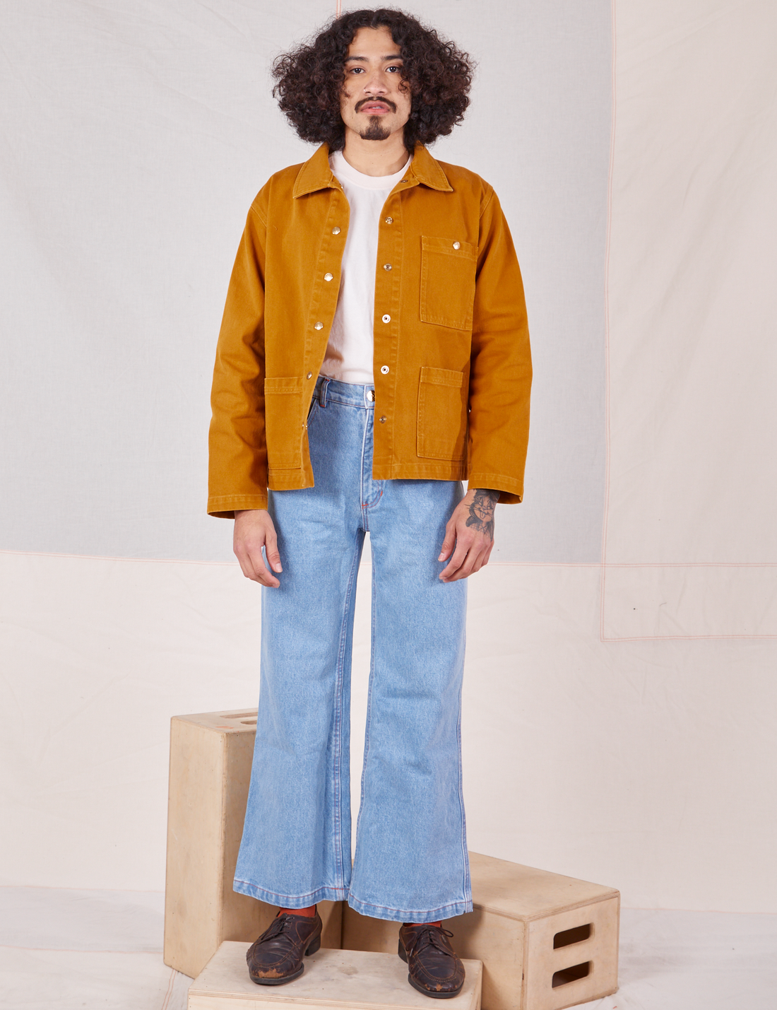 Jesse is 5'8" and wearing S Denim Work Jacket in Spicy Mustard