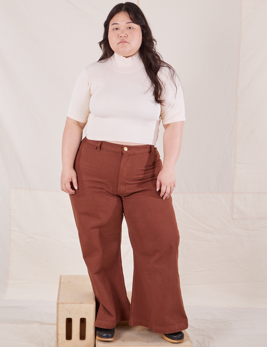 Ashley is wearing size M 1/2 Sleeve Essential Turtleneck in Vintage Off White paired with fudgesicle brown Bell Bottoms
