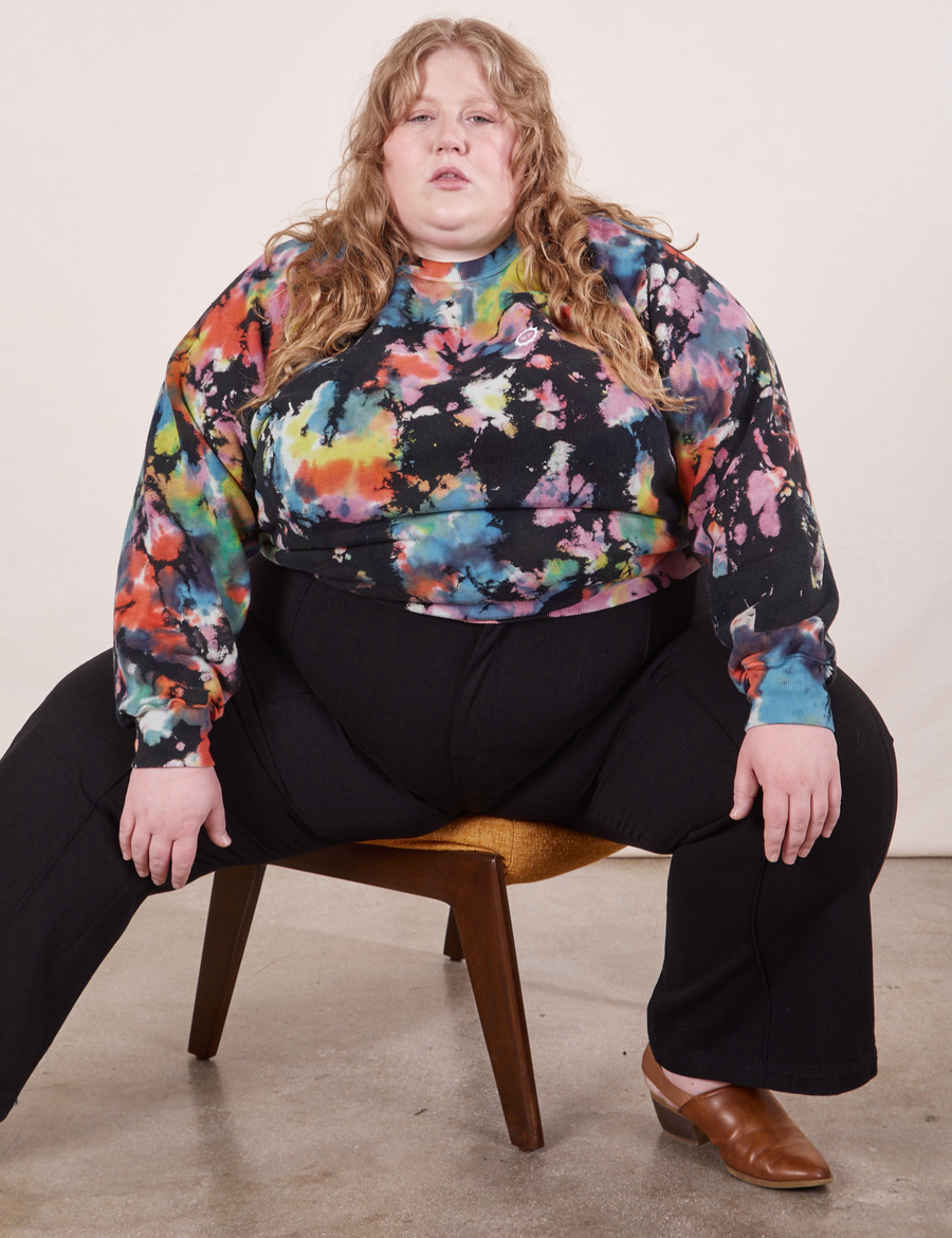 Catie is wearing Heavyweight Crew in Rainbow Magic Waters and black Western Pants