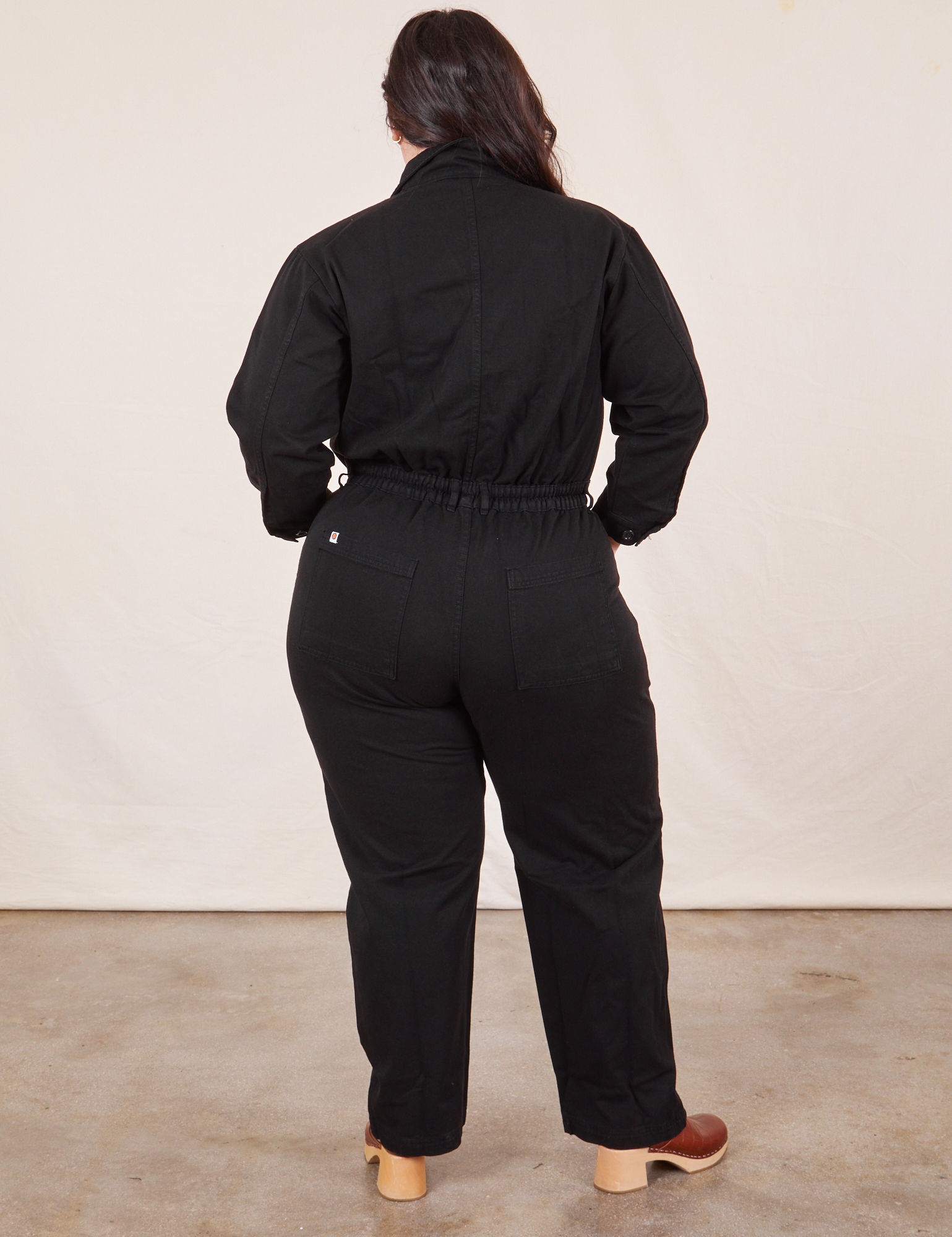 Back view of Everyday Jumpsuit in Basic Black worn by Ashley