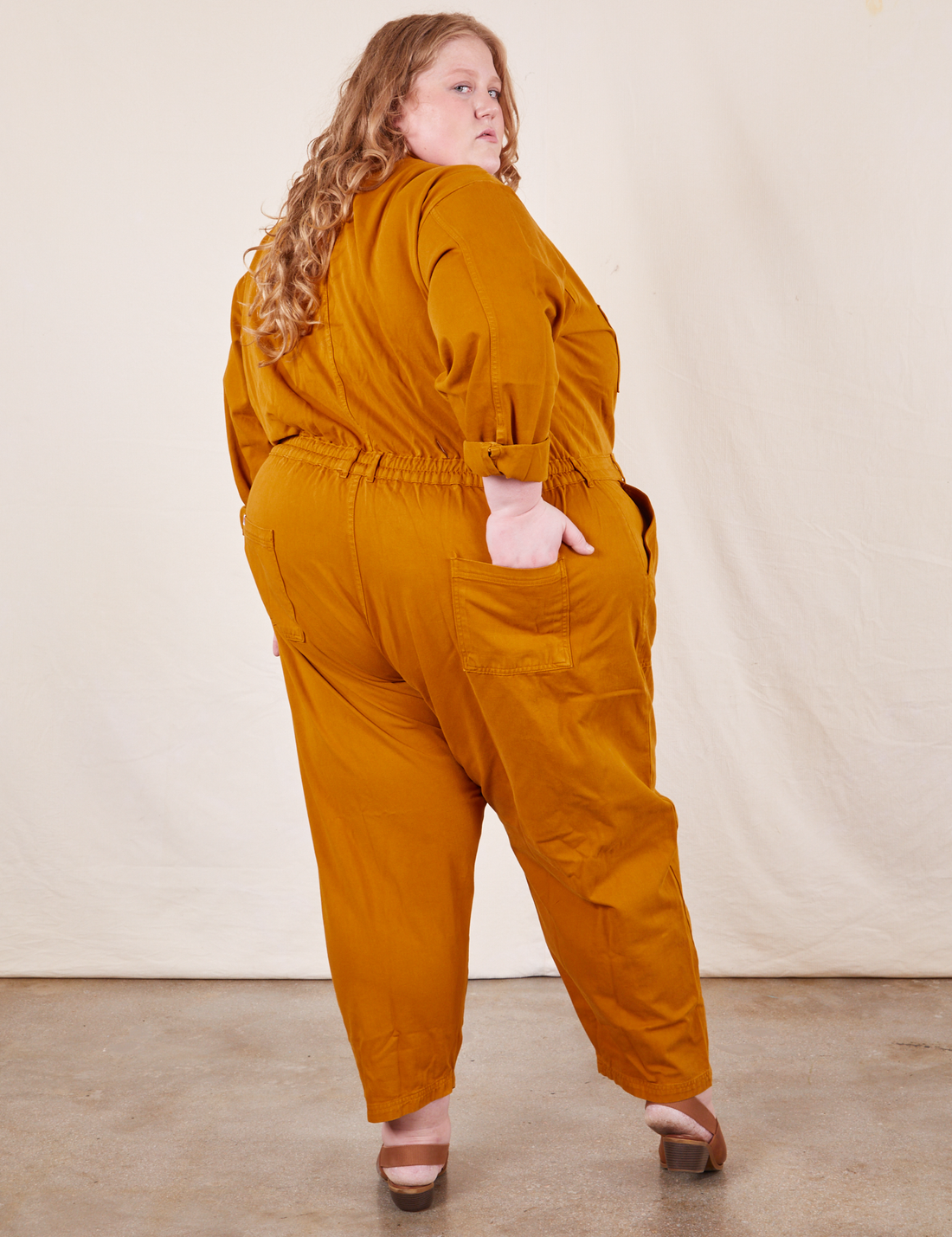 Back view of Everyday Jumpsuit in Spicy Mustard worn by Catie