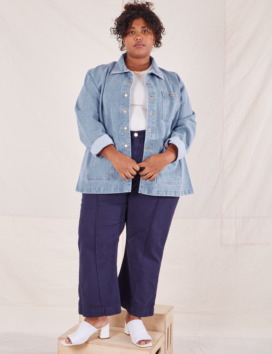 Morgan is 5'5" and wearing 1XL Indigo Denim Work Jacket in Light Wash paired with navy Western Pants