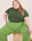 Catie is wearing Organic Vintage Tee in Dark Emerald Green and gross green Western Pants