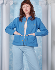 Alex is 5'8" and wearing size P Neoclassical Work Jacket in Blue Venus paired with vintage off-white Tank Top underneath jacket and baby blue Bell Bottoms