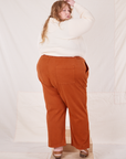 Angled back view of Organic Work Pants in Burnt Terracotta worn by Catie