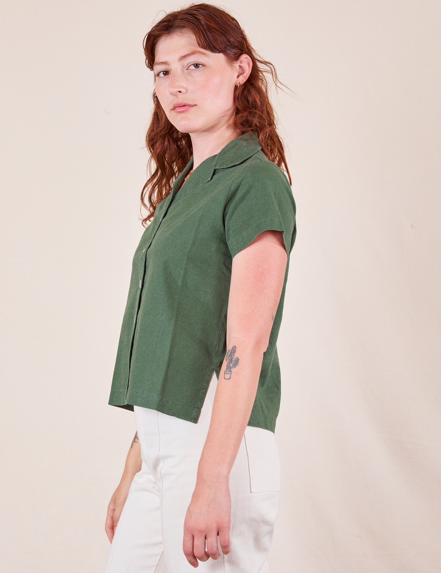 Side view of Pantry Button-Up in Dark Emerald Green worn by Alex