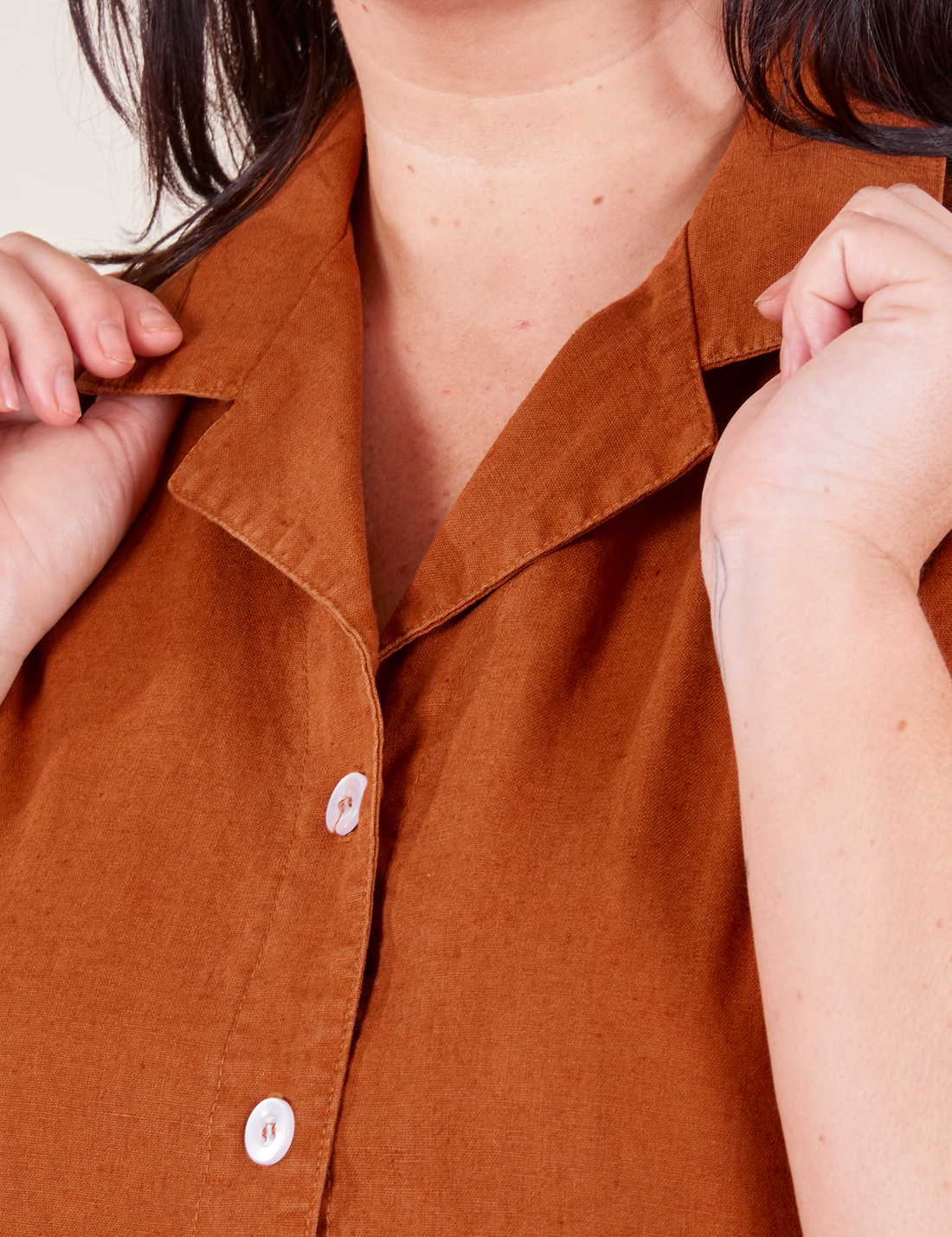 Pantry Button-Up in Burnt Terracotta Faye holding collar front close up