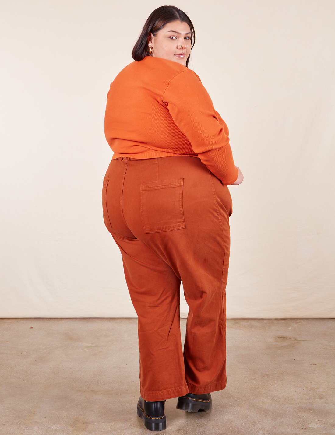 Western Pants in Burnt Terracotta back view on Sarita wearing burnt orange Long Sleeve V-Neck