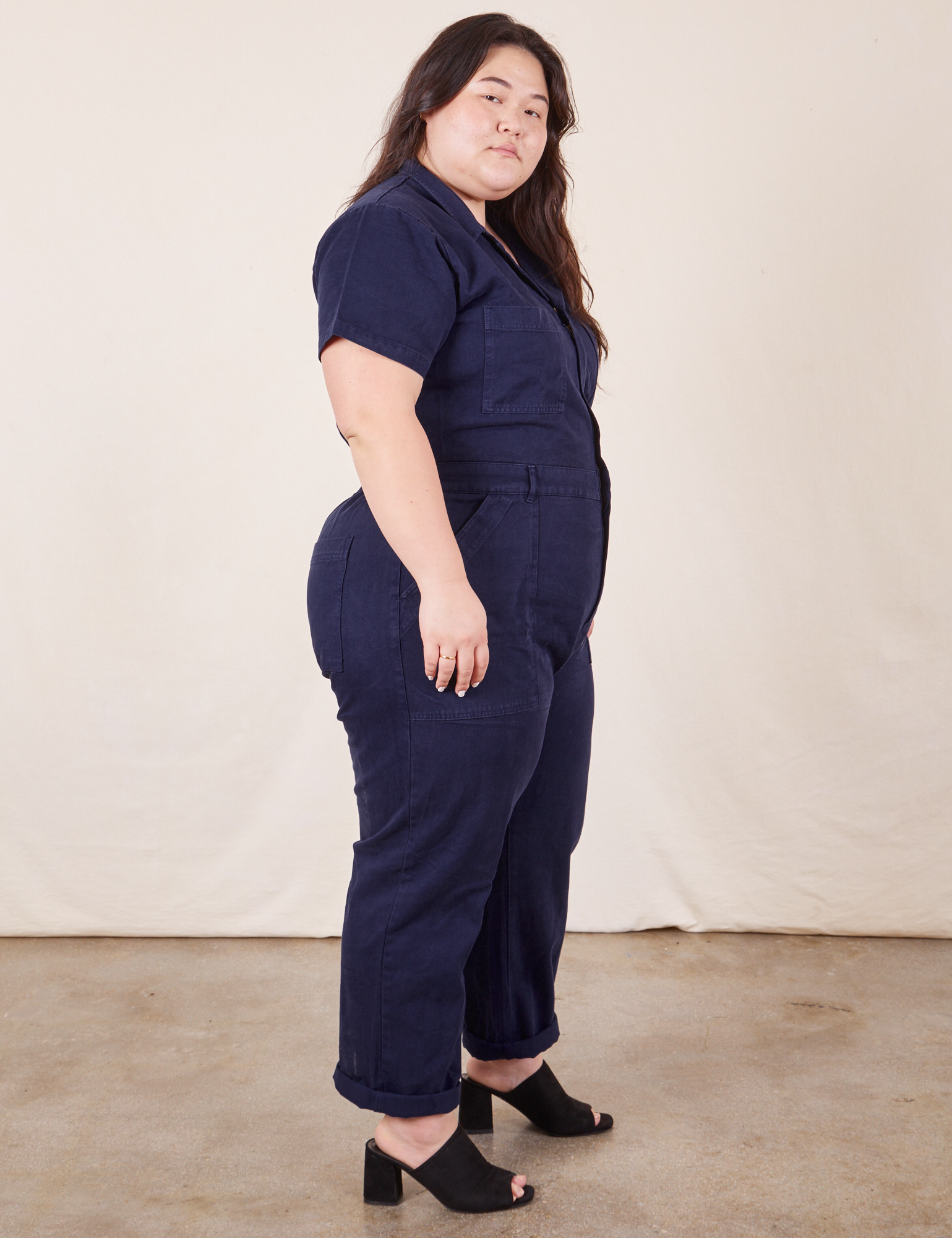 Side view of Short Sleeve Jumpsuit in Navy Blue worn by Ashley