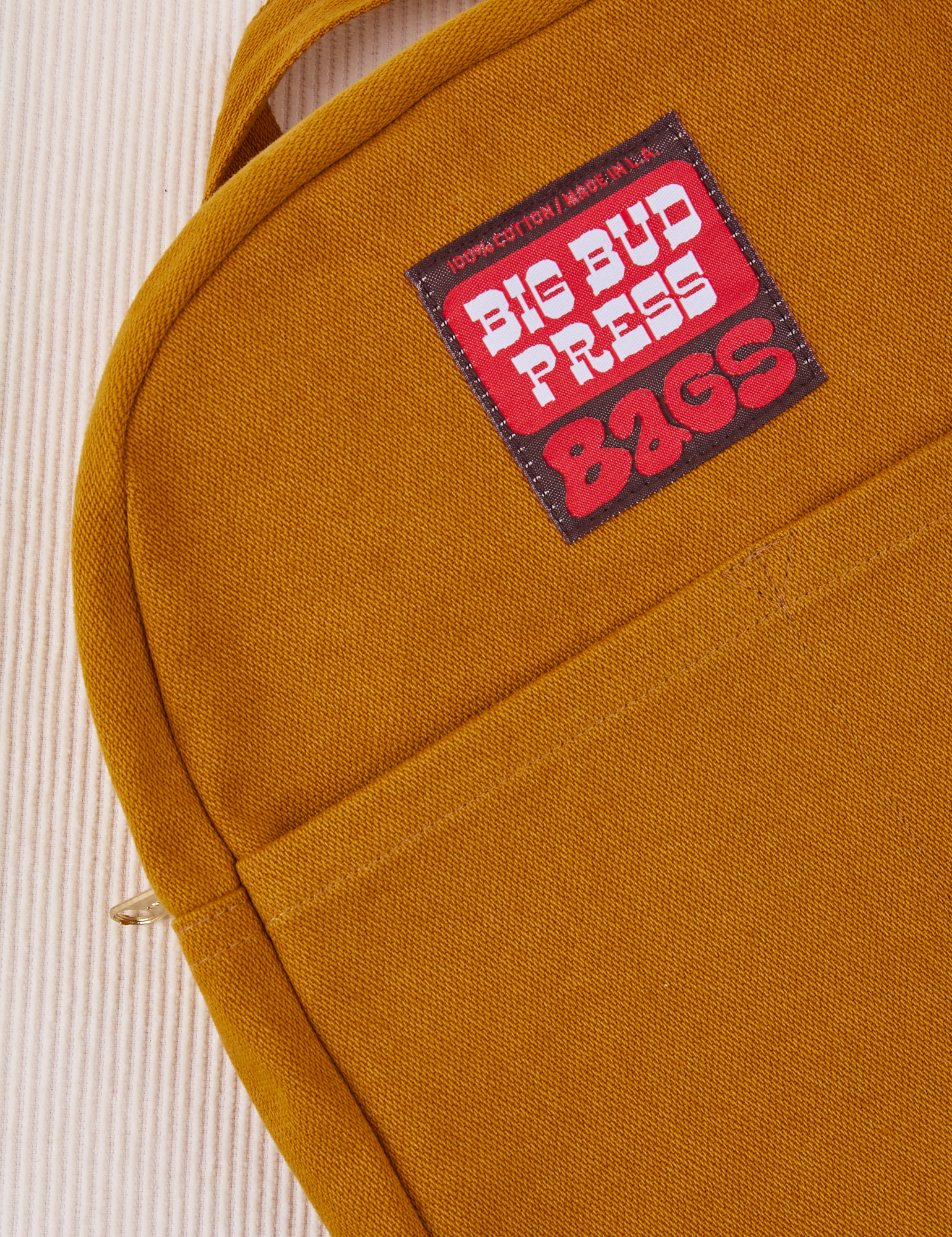 Mini Backpack in Spicy Mustard with brown and red Big Bud Press label