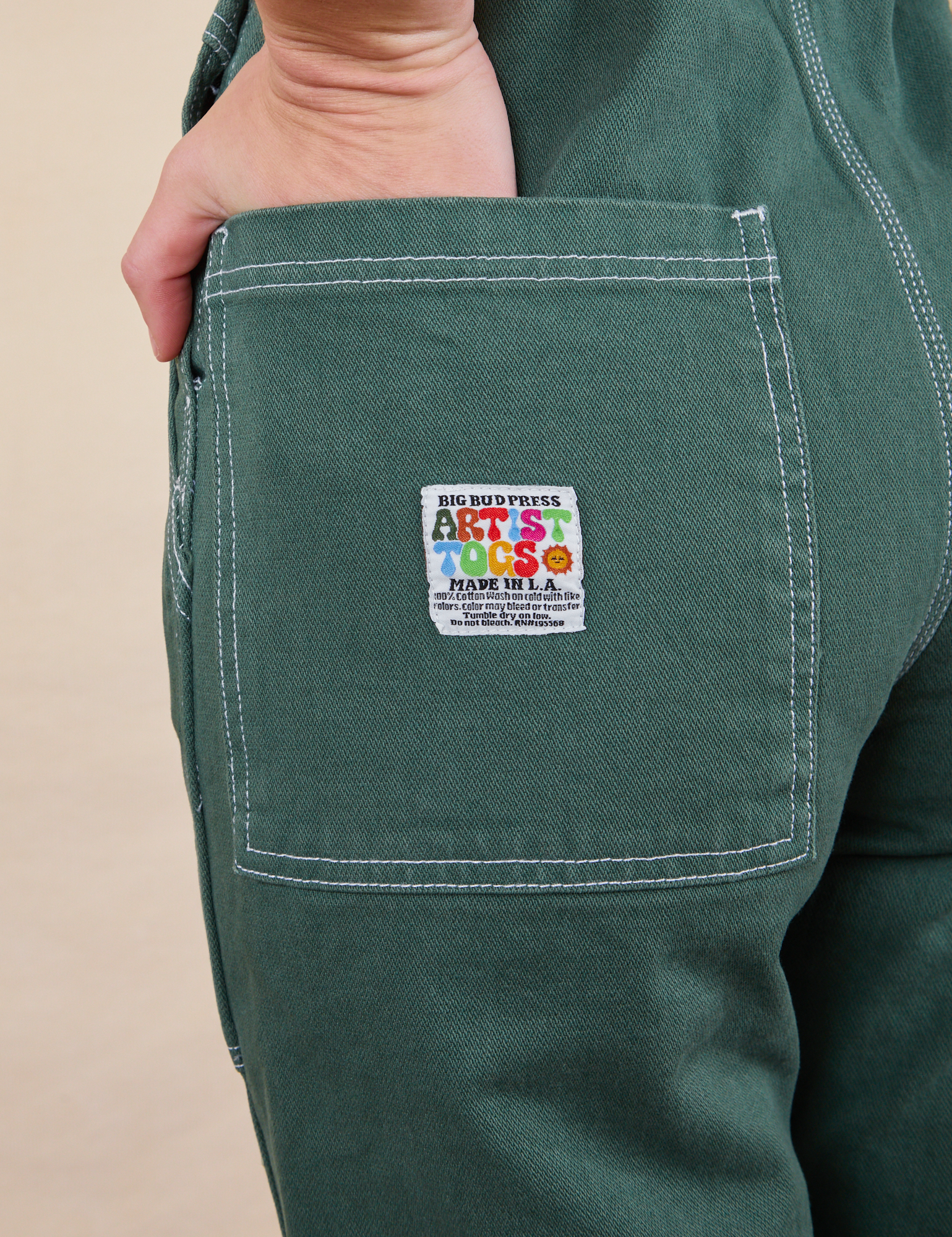 Original Overalls in Dark Emerald Green back pocket close up with Artist TOGS tag