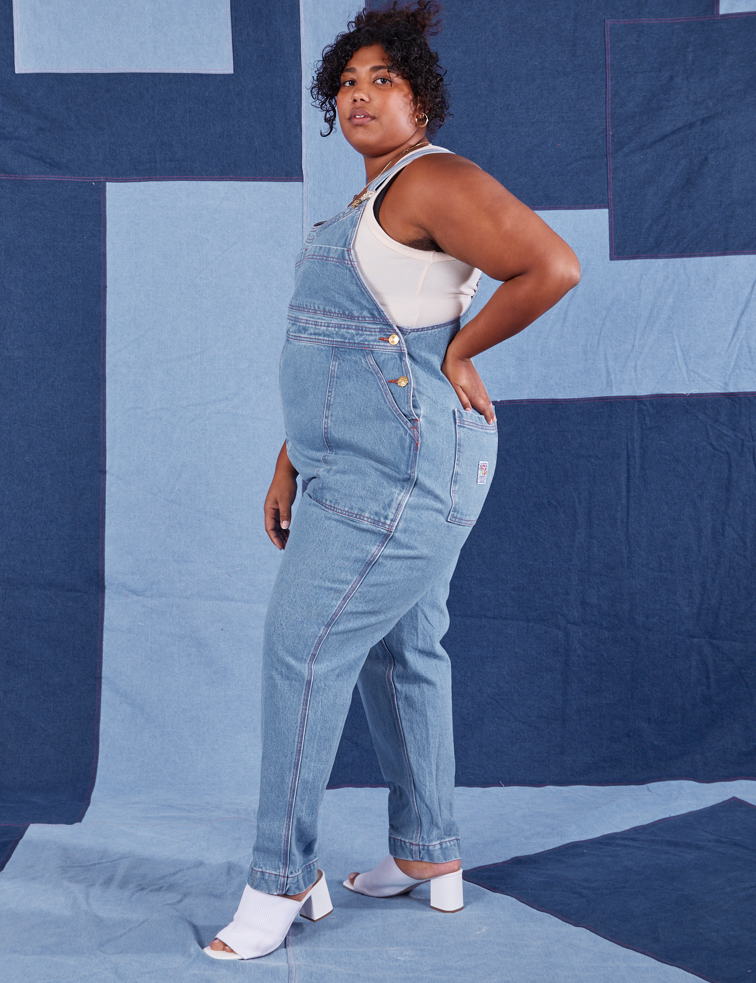 Side view of Indigo Denim Original Overalls in Light Wash worn by Morgan