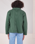 Back view of Denim Work Jacket in Dark Green Emerald worn by Jesse