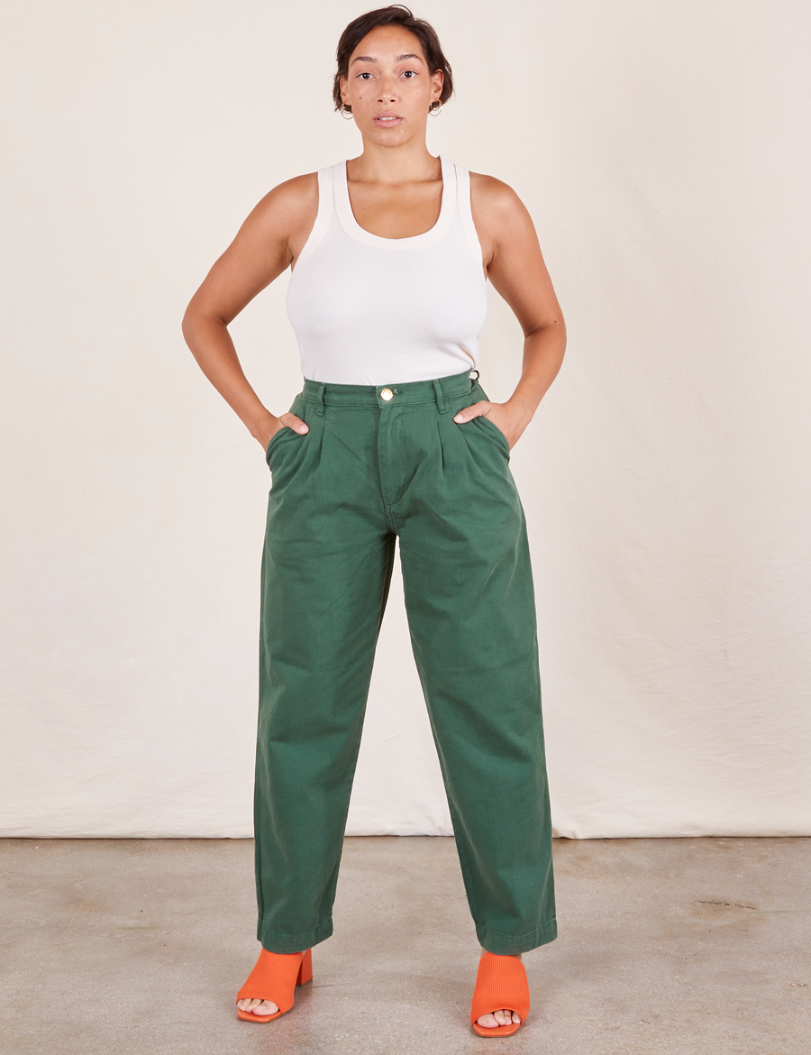 Tiara is 5'4" and wearing S Heavyweight Trousers in Dark Emerald Green paired with vintage off-white Tank Top