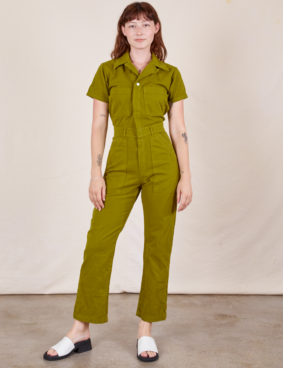 Alex is 5'8" and wearing XS Short Sleeve Jumpsuit in Olive Green