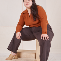 Ashley is wearing Long Sleeve Fisherman Polo in Burnt Terracotta and espresso brown Western Pants